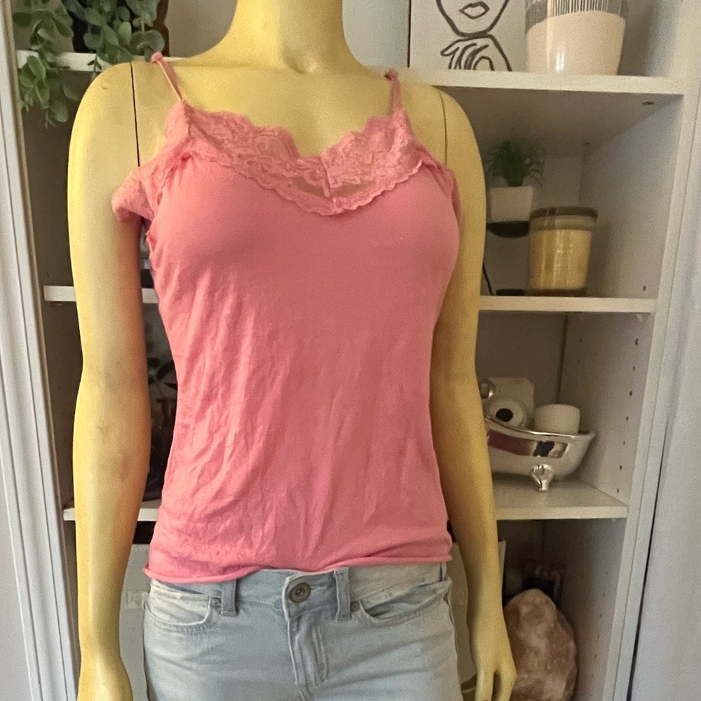 I am selling a pink tank top with a pretty design at the top.